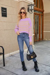 Outdoor street scene detail showing a cozy purple sweater with yellow stripes and long sleeves.