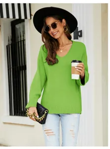 Detailed view of the casual green V-neck knit sweater, showing long sleeves and loose fit style.
