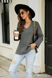 Detailed view of women's long sleeve V-neck knit sweater, casual loose fit and stylish design.