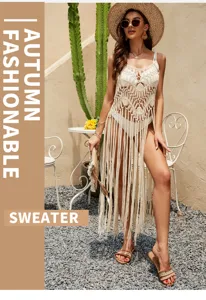 Detailed view of the hollow-out knit fringe beach cover-up worn by model outdoors in summer.