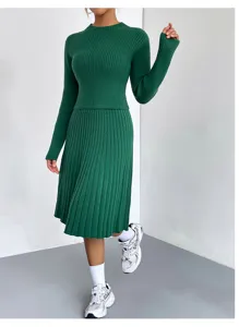 Detail view of the elegant green knit sweater and pleated skirt two-piece set, cozy wear.