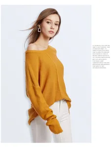 Detail view of casual loose off-shoulder knitted sweater in mustard yellow color cozy style