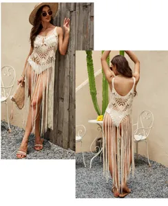 Details view of hollow-out crochet beach cover-up with long tassels and delicate straps.