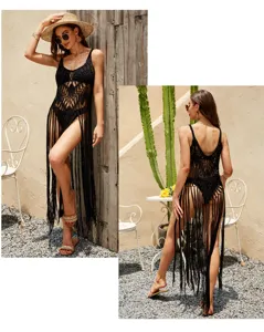 Detail of black crochet beach cover up with hollow knit and long fringe hem for summer.