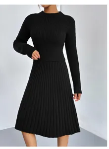Close-up detail of the black knit sweater and midi skirt set, highlighting ribbed texture.