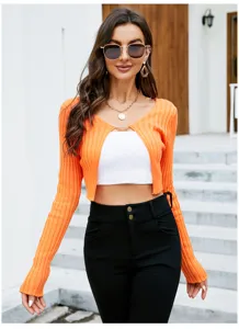 Close-up detail of the stylish ribbed knit cropped cardigan featuring long sleeves and color.