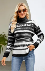 Detailed close-up of the women's black and white geometric turtleneck knit sweater.