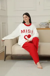Detailed view of women's cozy fleece loungewear set featuring heart graphic and text on sweater.