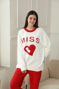Cozy winter long-sleeve pajama set featuring a cute heart and letter print design in home scene.