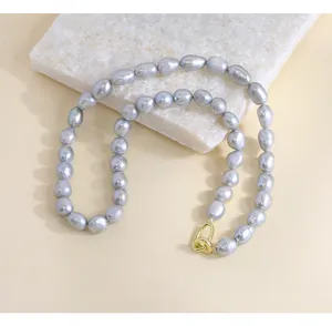Exquisite grey baroque pearl necklace detail close up view, vintage style jewelry display.