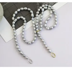 Detailed view of grey baroque pearl beaded chain with metallic rings, vintage literary style jewelry.