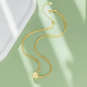 Gold multi-strand necklace with bead pendant, elegant clavicle chain for daily wear.