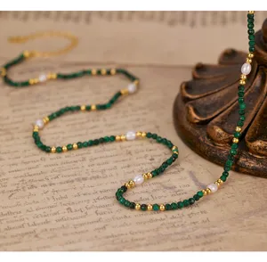 Vintage malachite gemstone and pearl beaded choker necklace, elegant detail view showing texture.
