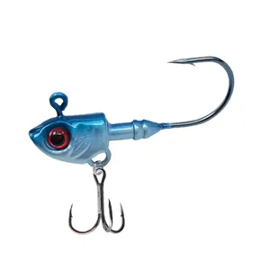 Blue fishing jig head lure with realistic red eyes and treble hook for sea fishing detail view.
