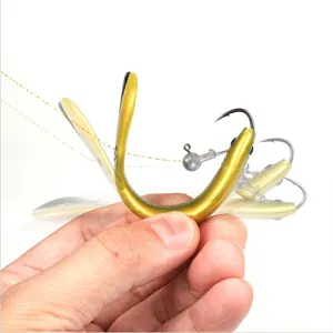 Close-up detail view of the soft plastic fishing lure with jig head, showing flexible action in hand.