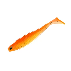 Detailed view of orange soft plastic swimbait fishing lure with paddle tail and textured body.
