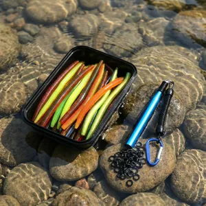 Detail view of bass fishing soft plastic worm rig accessories, including storage box and O-rings.