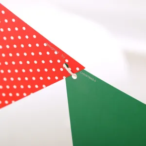 Detailed close-up shot of Christmas paper pennant bunting, red white polka dot and green flags.