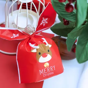Detailed shot of Christmas gift packaging bag with cute reindeer print and bunny ears design.