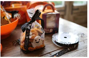Halloween gift wrapping ribbon and cookie candy bags set with festive pumpkin and ghost prints.