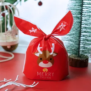 Christmas candy gift bag with cute reindeer cartoon design and bunny ears drawstring closure.