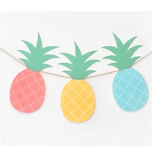 Pineapple paper garland banner detail featuring colorful pink, yellow and blue fruit shapes for party.