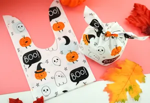 Halloween gift candy bag detail close-up showing cute pumpkin and ghost print patterns.