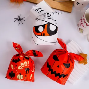 Halloween candy gift bags detail view showing cute mummy and pumpkin designs with bunny ears.