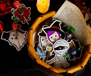 Close-up detail of Halloween lollipop holder cards featuring cute witch and mummy designs.