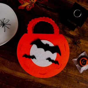 Halloween kids felt candy bag detail showcasing cute bat and moon design on orange tote.