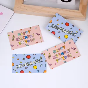 Detailed view of cute pink and blue cartoon greeting cards for birthday gift packaging.