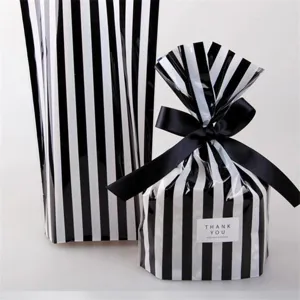 Black and white striped gift packaging bag with black ribbon and thank you label detail.