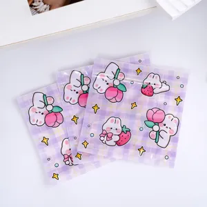 Cute cartoon rabbit ziplock bag detail view, purple grid candy packaging and small storage pouch.