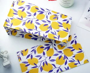 Lemon print paper gift bag detail view, fresh fruit pattern design for stylish packaging and presents.