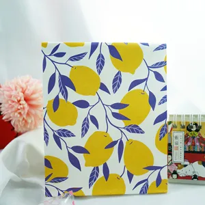 Lemon pattern paper gift bag detail view, fresh botanical design for presents and party favors.