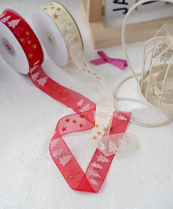 Red and beige Christmas organza ribbon detail, gold star and tree pattern for gift wrap