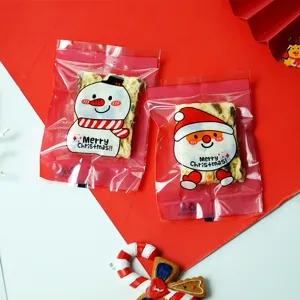 Christmas cellophane cookie bags with cute snowman and Santa Claus designs for holiday gifts.