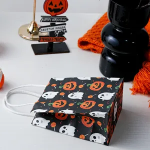 Halloween mini paper gift bag featuring cute ghost and pumpkin pattern detail view.