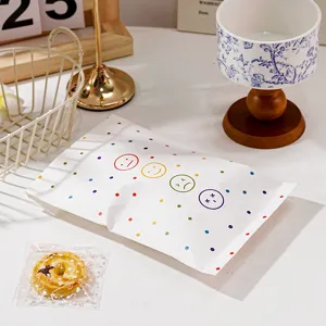 Sacchetto di carta bianca con pois colorati e simpatiche emoji per regali e confezioni.