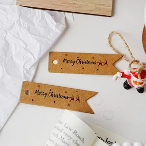 Vintage kraft paper swallowtail gift tags with Merry Christmas print for holiday decoration.