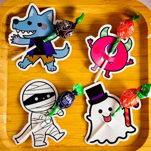 Close-up detail of Halloween lollipop cards, cute cartoon monster designs for DIY paper crafts.