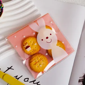 Cute rabbit candy self-adhesive bag detail showing pink printed design and biscuit packaging inside clearly.