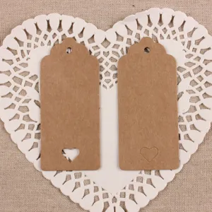 Vintage kraft paper hang tags with scalloped edges and heart cutouts for gifts and baking.