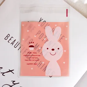 Cute pink rabbit self-adhesive cookie and candy packaging bag, bakery gift detail view.