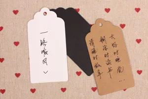 Detail shot of multi-color paper gift tags with handwritten quotes for message card use.