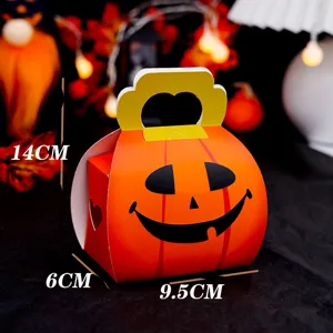 Halloween pumpkin paper candy gift box with handle and hollow design for cookie packaging.