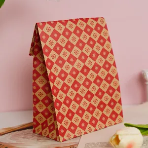 Vintage red leaf pattern paper gift bag with folded top design, ideal for retail and gifting.
