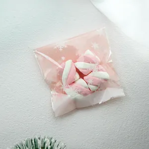 Pink snowflake self-adhesive plastic bag with sweet pink and white twisted marshmallows gift.