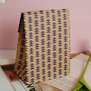 Detail view of a vintage brown kraft paper gift bag with blue triangle leaf pattern design.