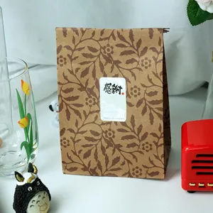 Kraft paper gift bag detail, retro leaf pattern, flat opening shopping packaging bag.